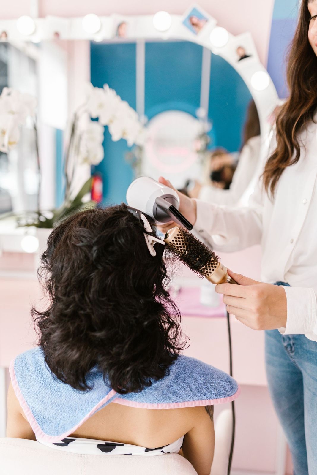 Escova e secador em cabelo cacheado dentro do salão